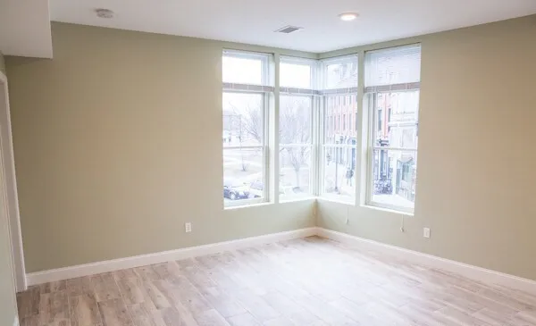 an empty room with windows and closet