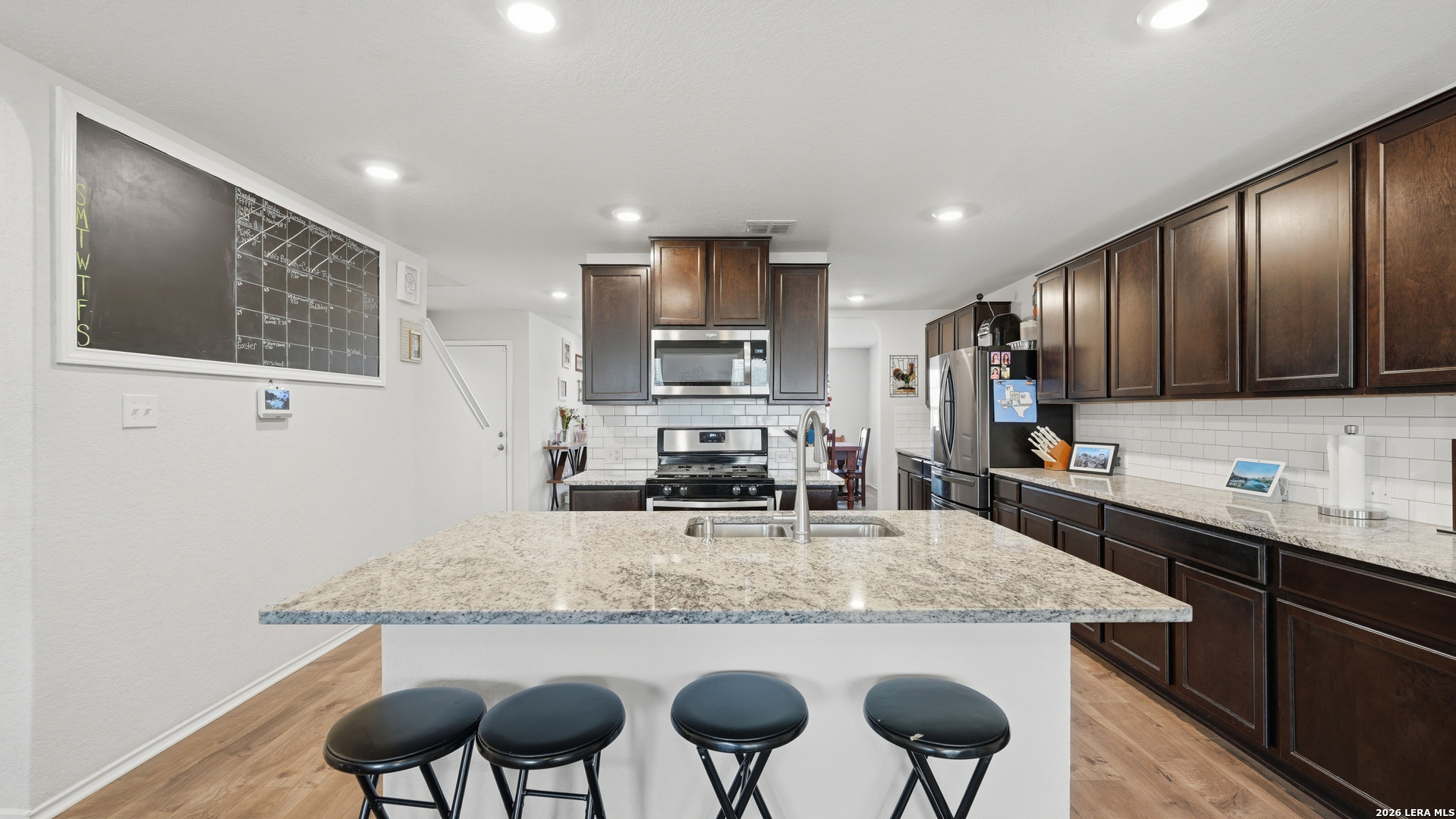 3649 Copper Bulverde, TX 78163 - Photo 11 of 45 a kitchen with granite countertop stainless steel appliances and wooden cabinets