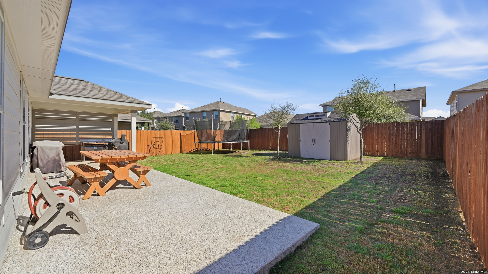 3649 Copper Bulverde, TX 78163 - Photo 2 of 45 a view of a backyard with table and chairs with wooden fence