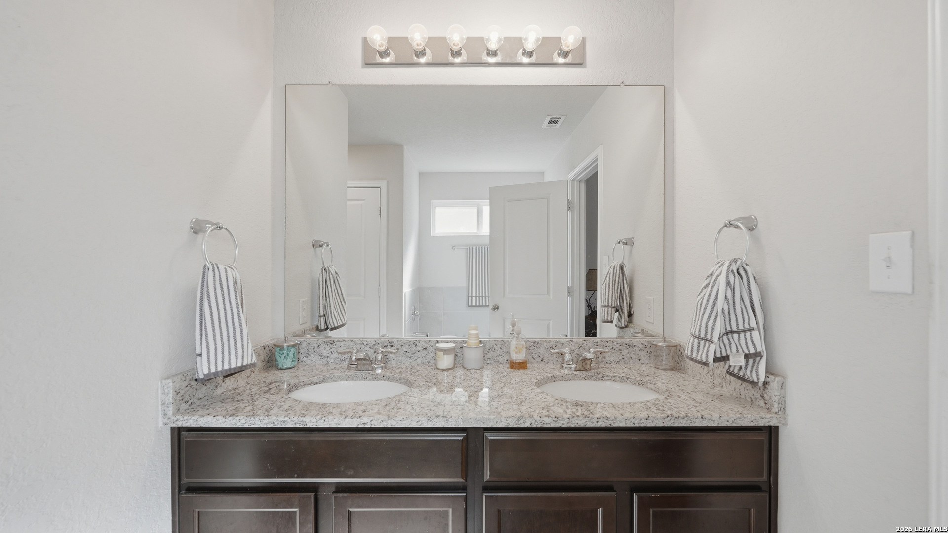 3649 Copper Bulverde, TX 78163 - Photo 24 of 45 a bathroom with a granite countertop sink and a mirror