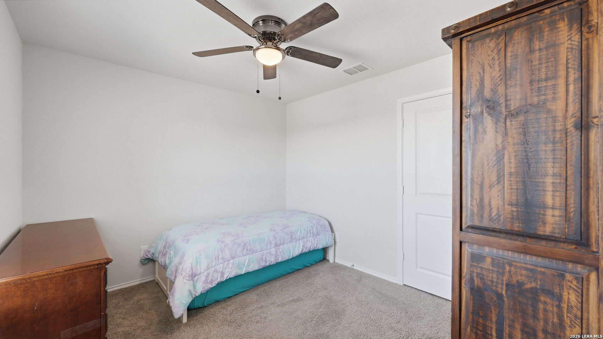 3649 Copper Bulverde, TX 78163 - Photo 29 of 45 a bedroom with a bed and a chandelier