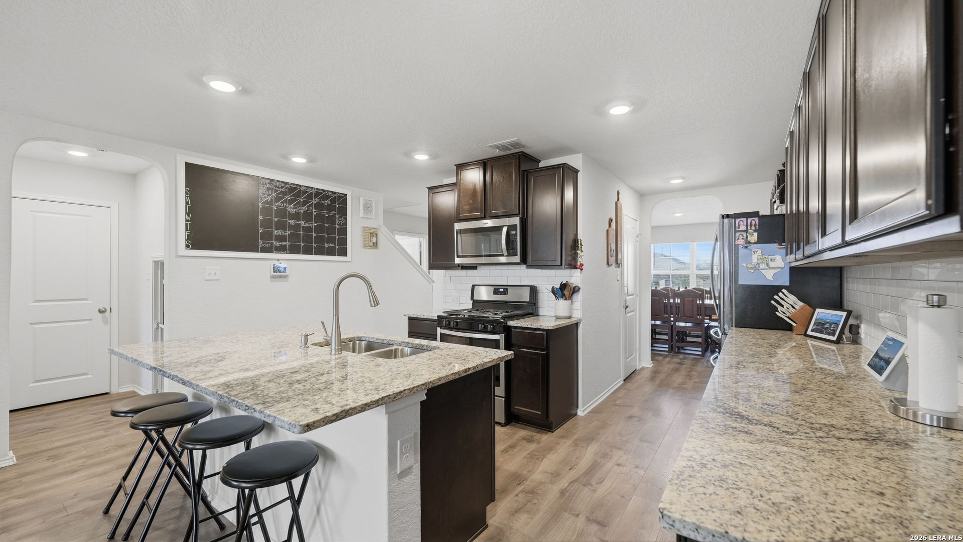 3649 Copper Bulverde, TX 78163 - Photo 9 of 45 a kitchen with granite countertop stainless steel appliances and wooden cabinets