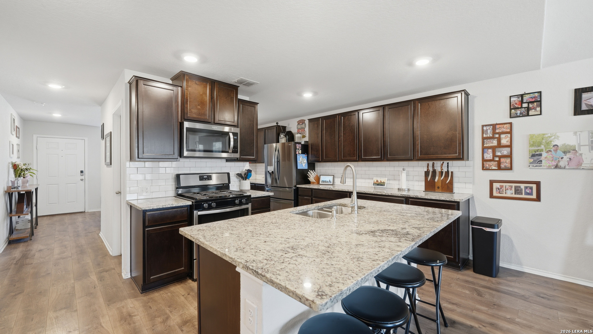 3649 Copper Bulverde, TX 78163 - Photo 10 of 45 a kitchen with granite countertop kitchen island stainless steel appliances a stove refrigerator sink and cabinets