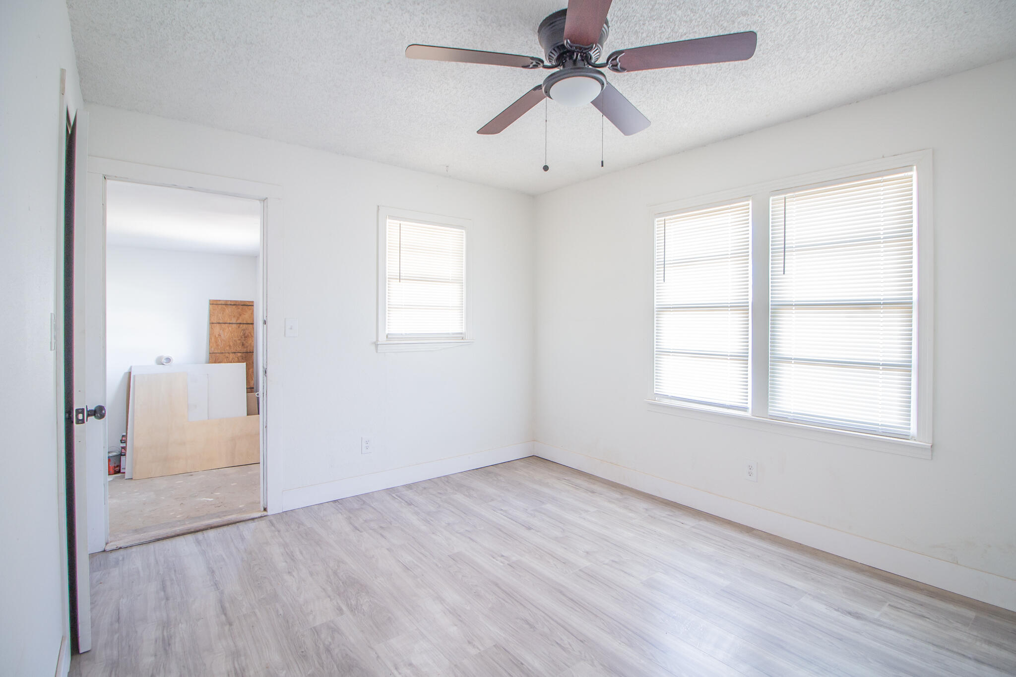 302 Avenue U Lubbock, TX 79415 - Photo 17 of 26 wooden floor in an empty room with a window