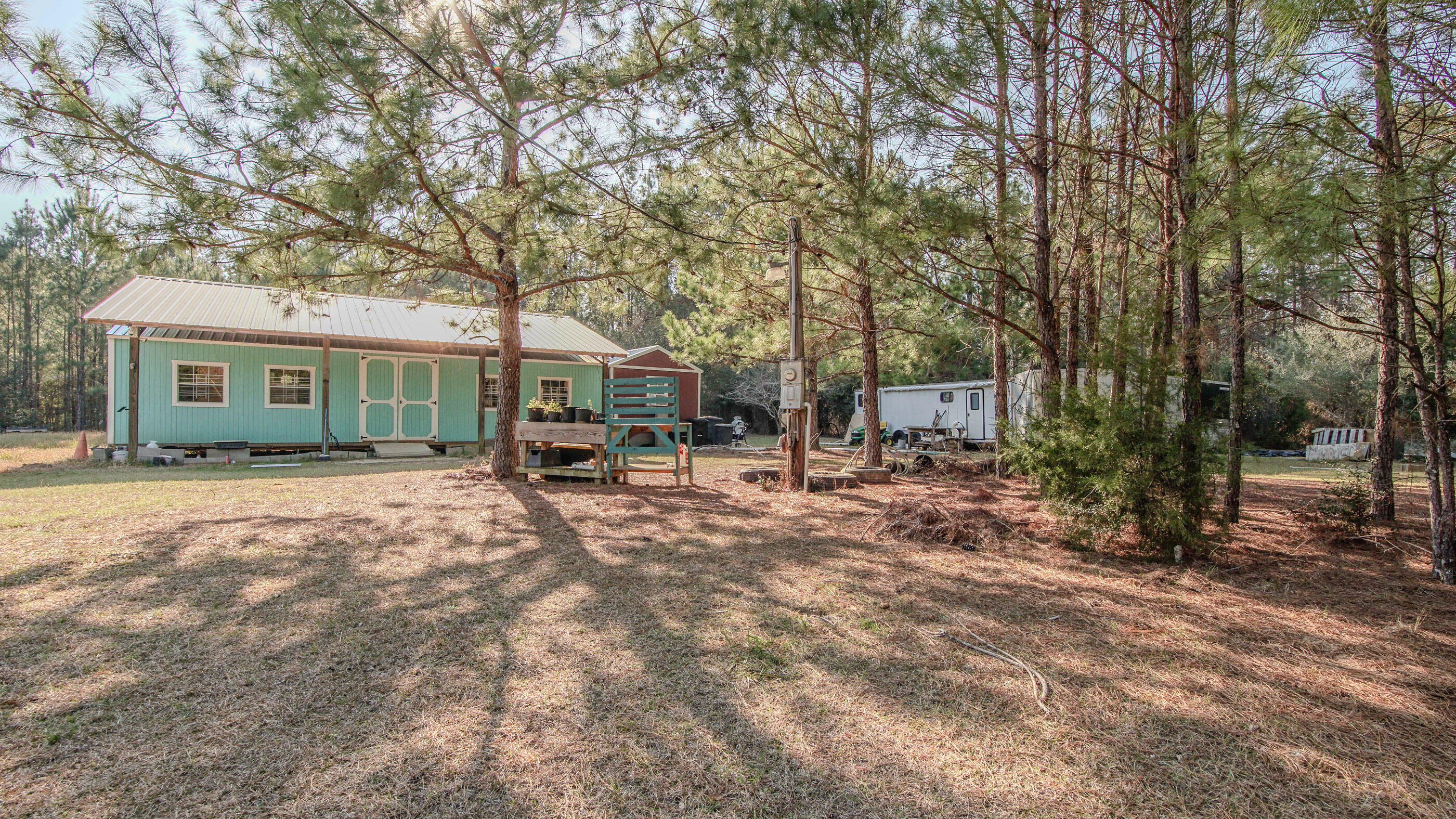 a view of house with yard and sitting area
