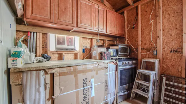 a kitchen with stainless steel appliances granite countertop a refrigerator and a stove top oven