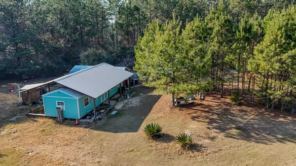 a view of a house with a yard and garage