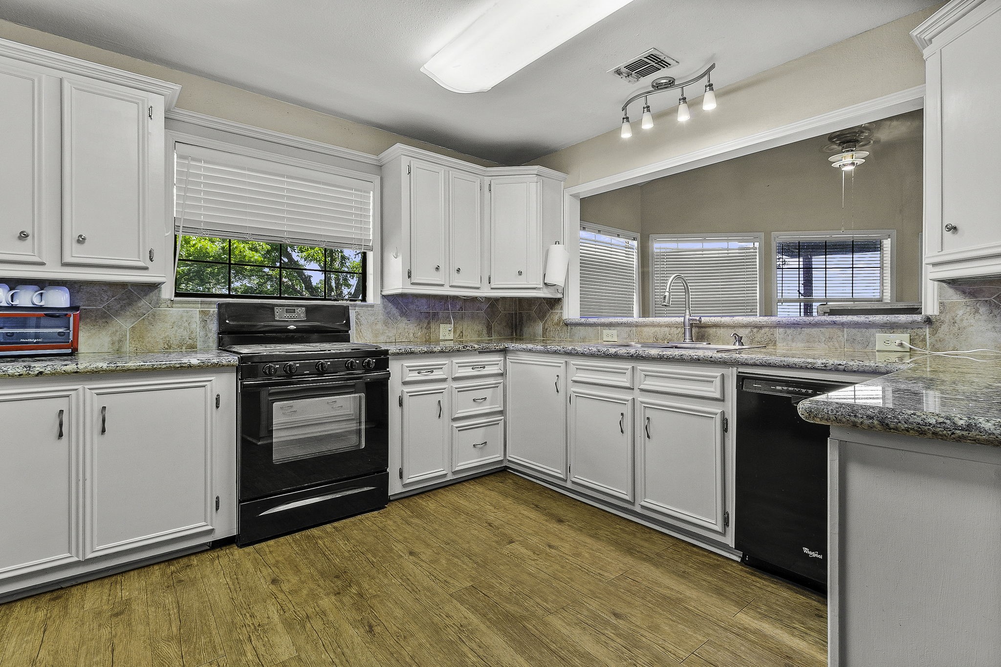 536 Weavers Cove Road Livingston, TX 77351 - Photo 10 of 44 a kitchen with granite countertop a stove sink and cabinets
