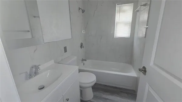 a bathroom with a sink a toilet and bathtub