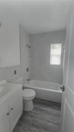 a bathroom with a sink a toilet and a bathtub