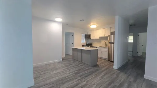 a kitchen with a refrigerator and a stove top oven