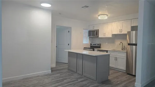 a kitchen with a sink cabinets and stainless steel appliances
