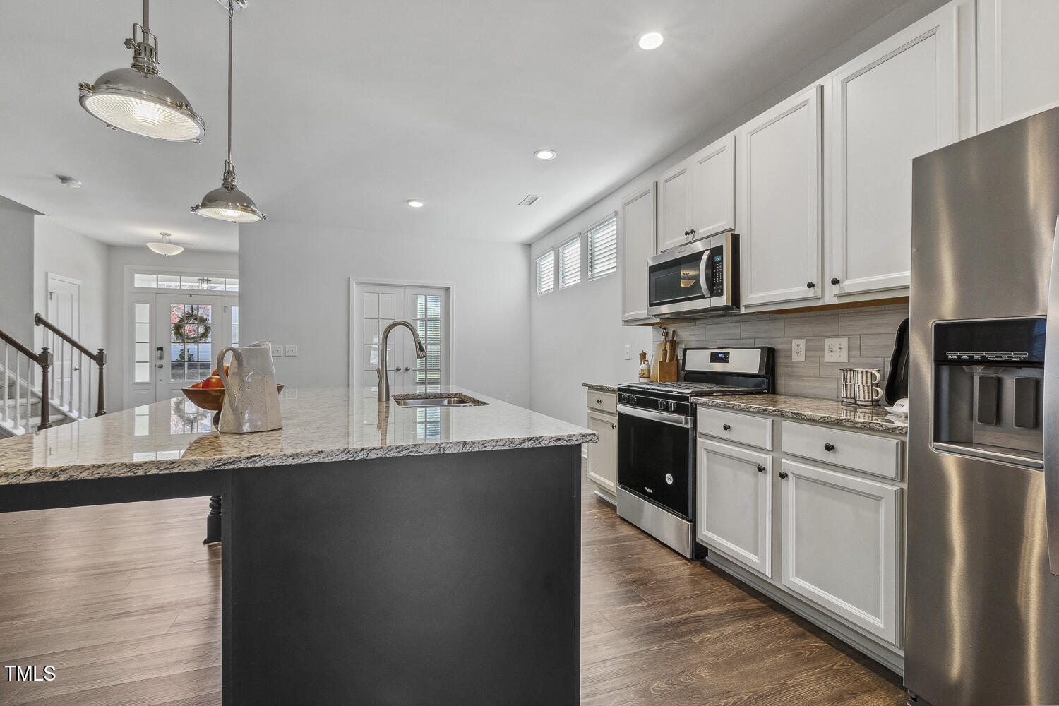 232 Big Barn Drive Wendell, NC 27591 - Photo 12 of 56 a kitchen with stainless steel appliances granite countertop a sink a stove and a refrigerator