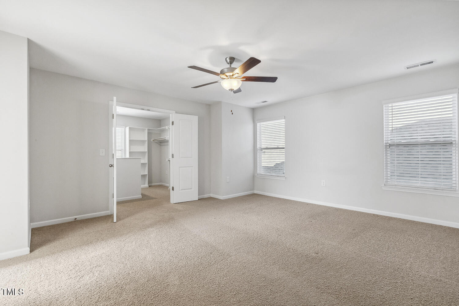 232 Big Barn Drive Wendell, NC 27591 - Photo 36 of 56 an empty room with chandelier fan and windows