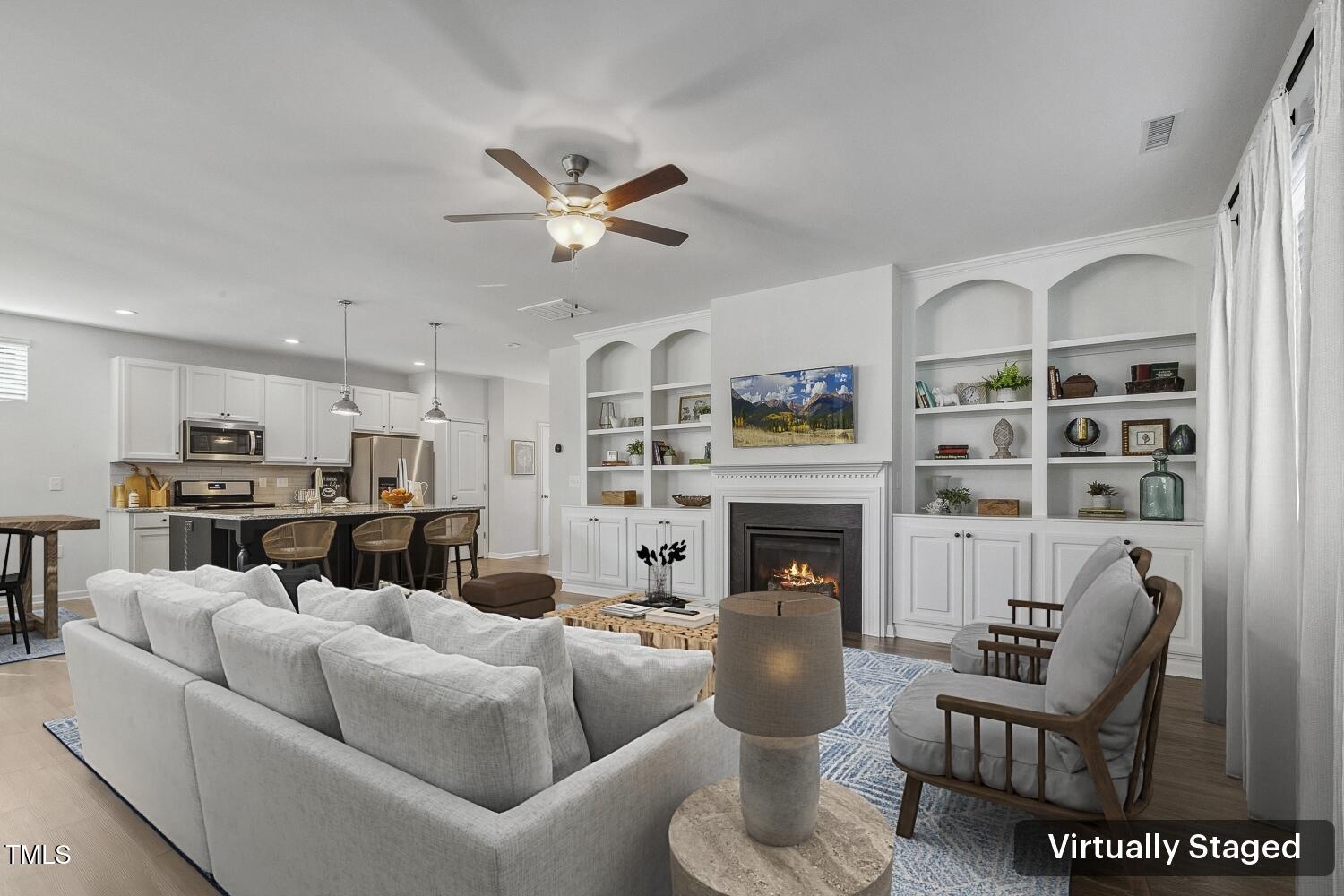 232 Big Barn Drive Wendell, NC 27591 - Photo 9 of 56 a living room with furniture a fireplace and a flat screen tv