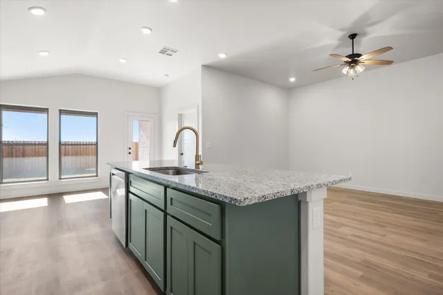 a kitchen with a sink a counter space and a window