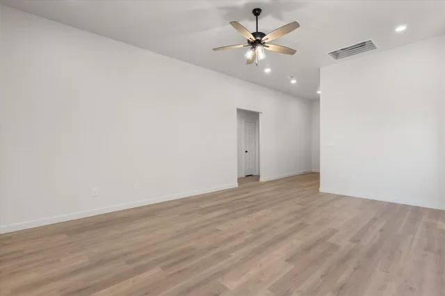 a view of an empty room with a fan