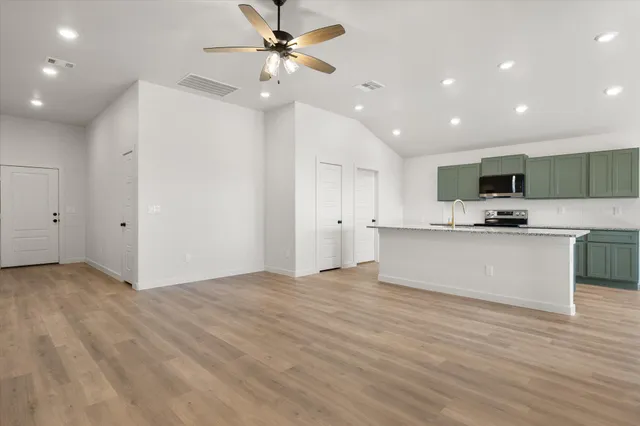 a view of kitchen with microwave and cabinets