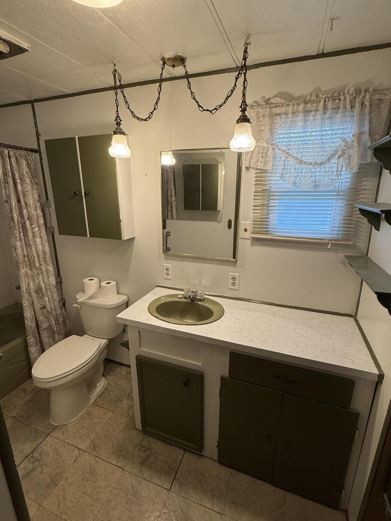421 Stevens Road, Unit 20 Eagle Point, OR 97524 - Photo 15 of 22 a bathroom with a sink a toilet and mirror