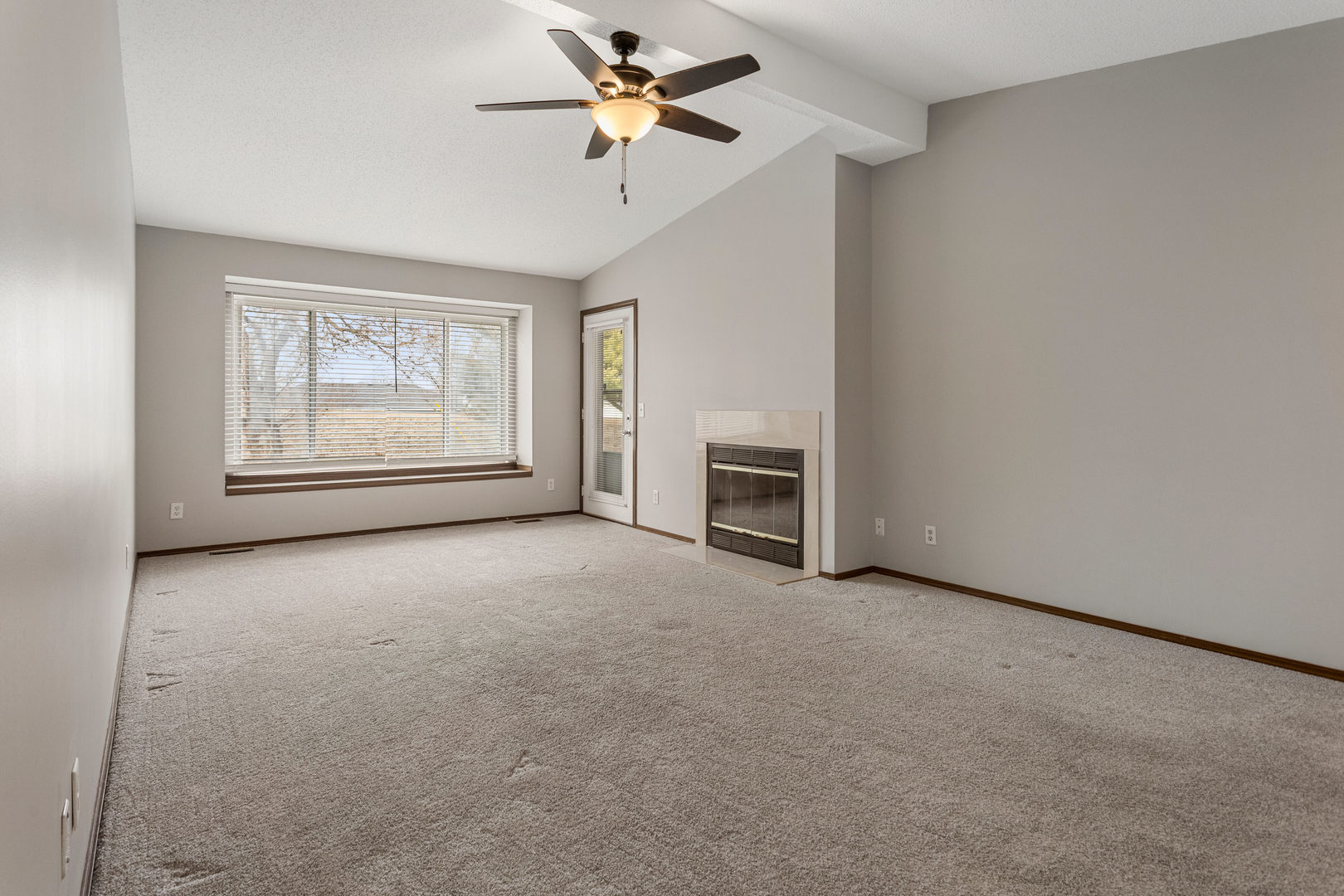 413 Irvine Road, Unit 413 Champaign, IL 61822 - Photo 6 of 29 an empty room with chandelier fan and windows