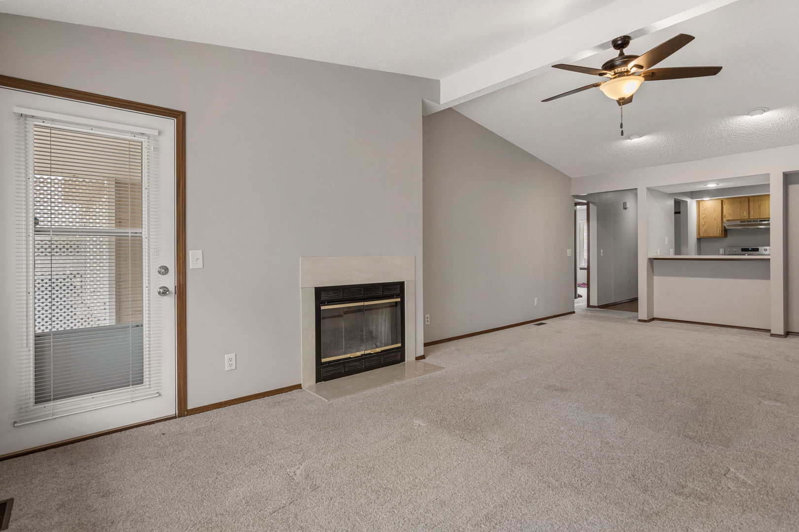 413 Irvine Road, Unit 413 Champaign, IL 61822 - Photo 7 of 29 a view of a livingroom with a ceiling fan a kitchen space a ceiling fan and wooden floor