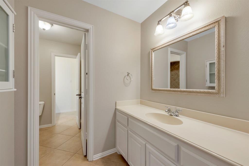 701 Buffalo Springs Drive Prosper, TX 75078 - Photo 13 of 15 a bathroom with a sink double vanity and a mirror