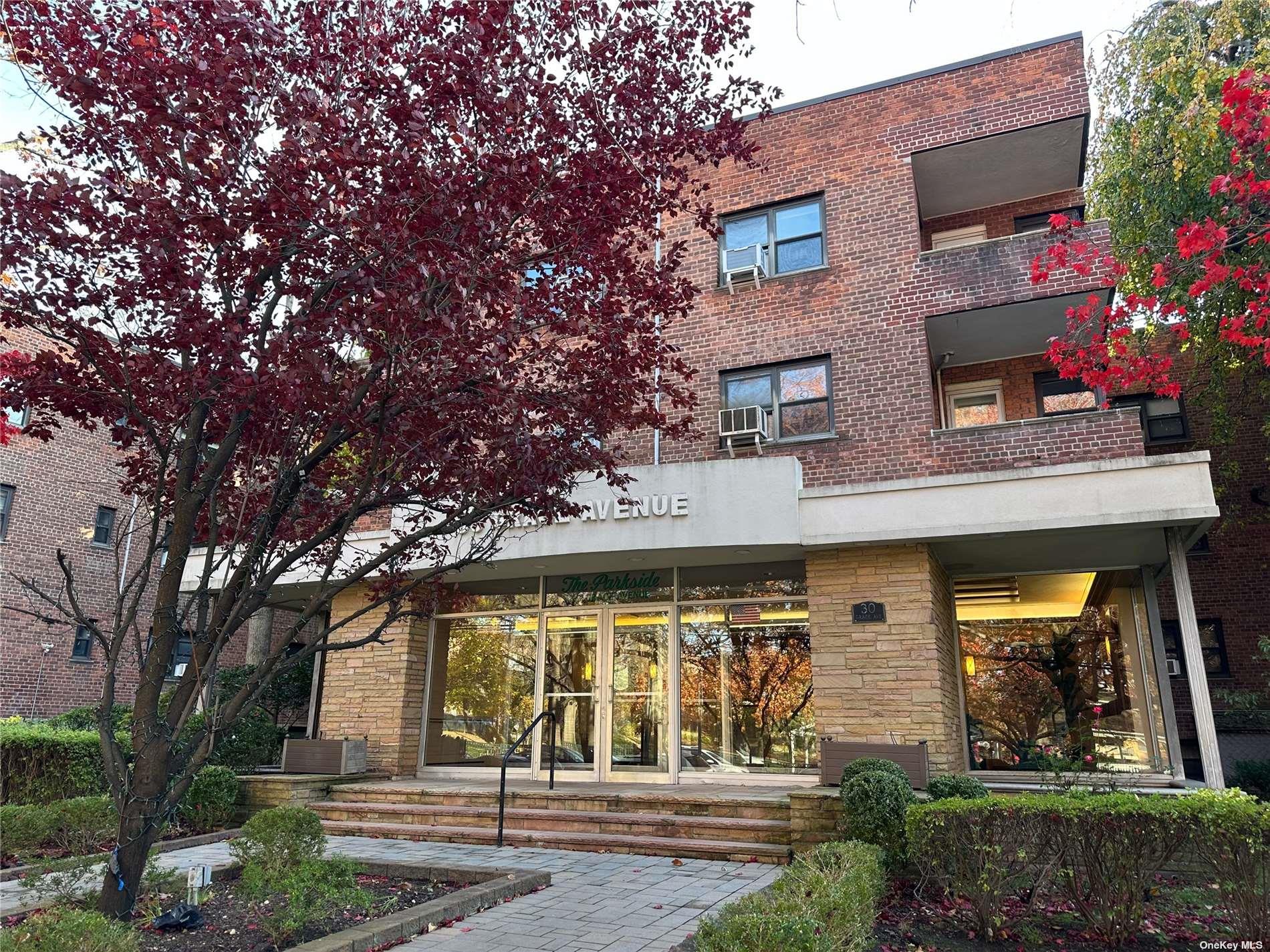 a front view of a building with garden