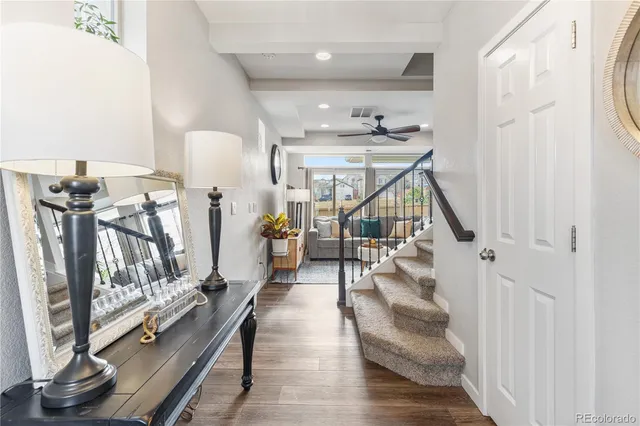 a view of entryway and hall with wooden floor