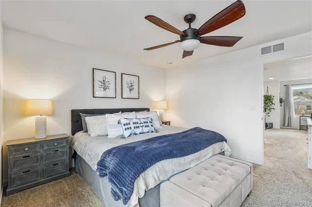 a bedroom with a large bed and a chandelier