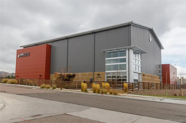 a city street lined with buildings and cars parked on the roadside