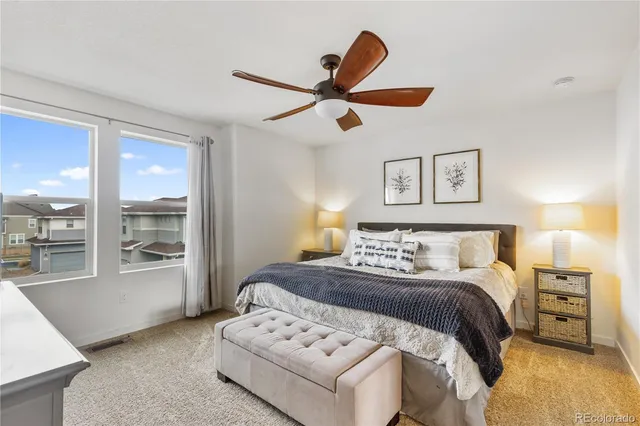 a bedroom with a large bed and a window