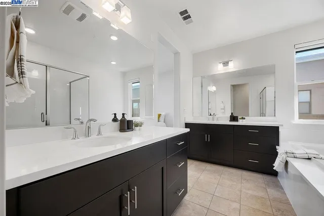 a bathroom with a double vanity sink and mirror