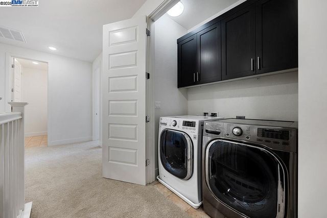 a view of a storage and utility room with a washer dryer