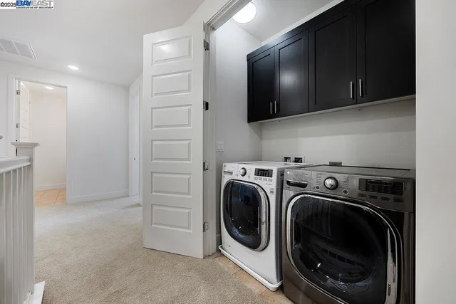 a view of a storage and utility room with a washer dryer