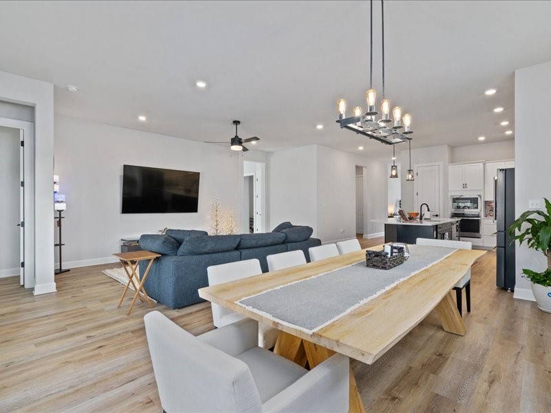 a view of a dining room with furniture wooden floor and chandelier