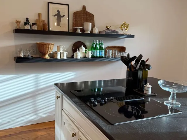 a kitchen with stainless steel appliances granite countertop a stove and a refrigerator
