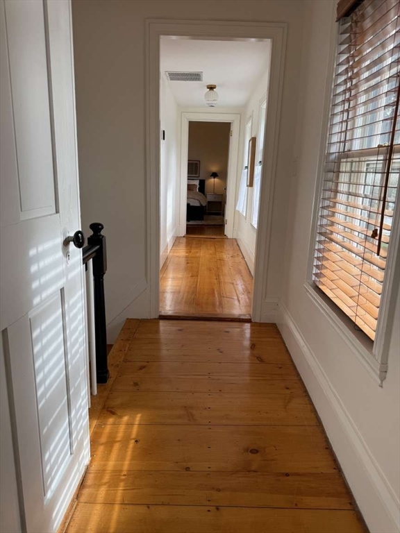 105 Elm Street, Unit A Andover, MA 01810 - Photo 21 of 40 a view of a hallway with wooden floor and staircase