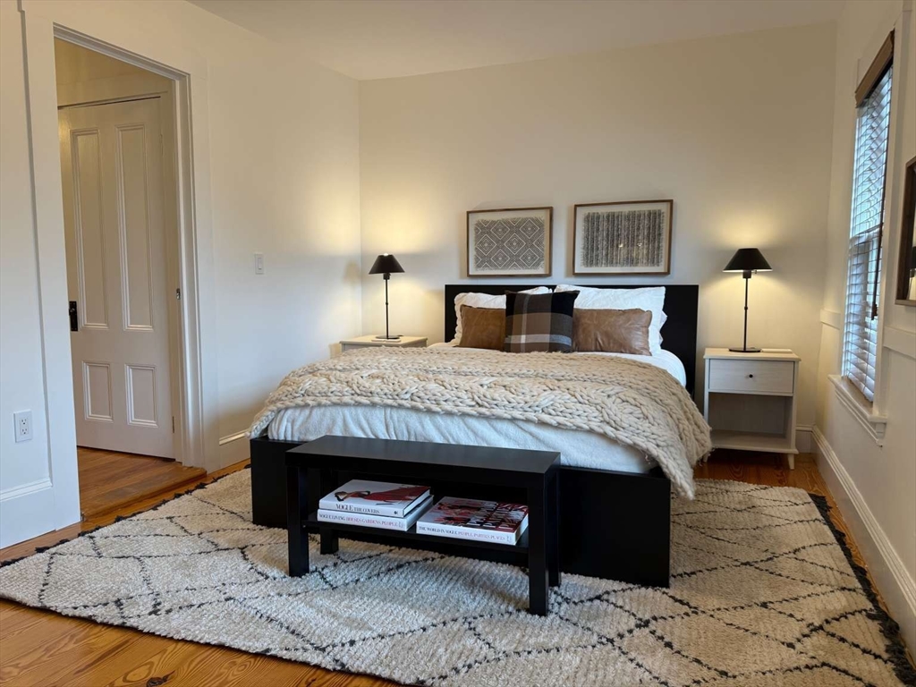 105 Elm Street, Unit A Andover, MA 01810 - Photo 22 of 40 a bedroom with a bed and wooden floor
