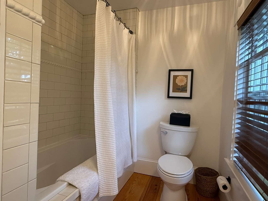 105 Elm Street, Unit A Andover, MA 01810 - Photo 25 of 40 a white toilet sitting next to a bathroom sink