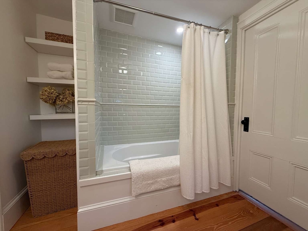 105 Elm Street, Unit A Andover, MA 01810 - Photo 29 of 40 a bathroom with a shower and a tub