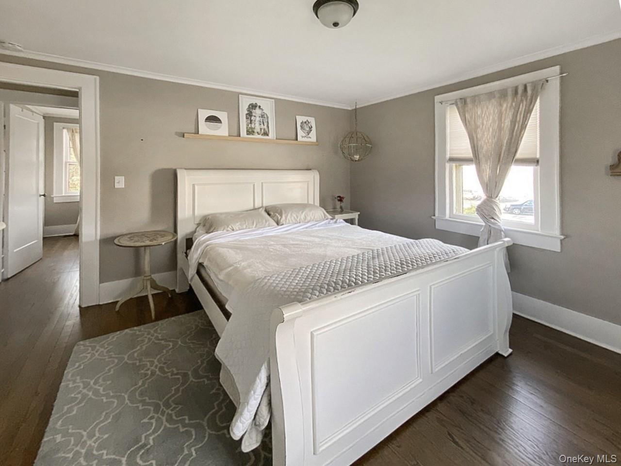 2490 Pike Street Mattituck, NY 11952 - Photo 11 of 15 Bedroom with dark wood-type flooring and ornamental molding