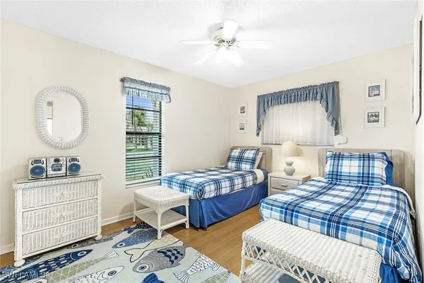 a bedroom with two beds and a dresser