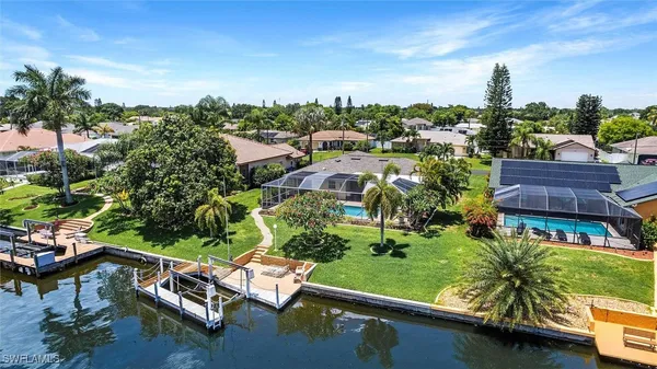 an aerial view of multiple houses with a yard