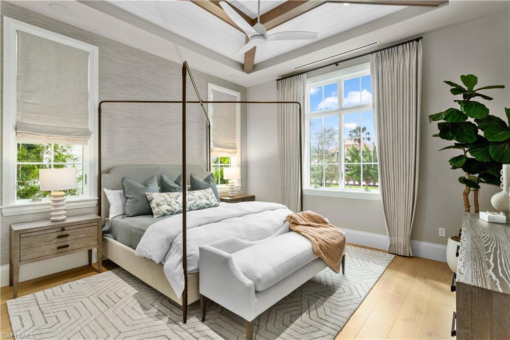 835 11th Avenue South Naples, FL 34102 - Photo 14 of 31 a bedroom with a large bed and a potted plant
