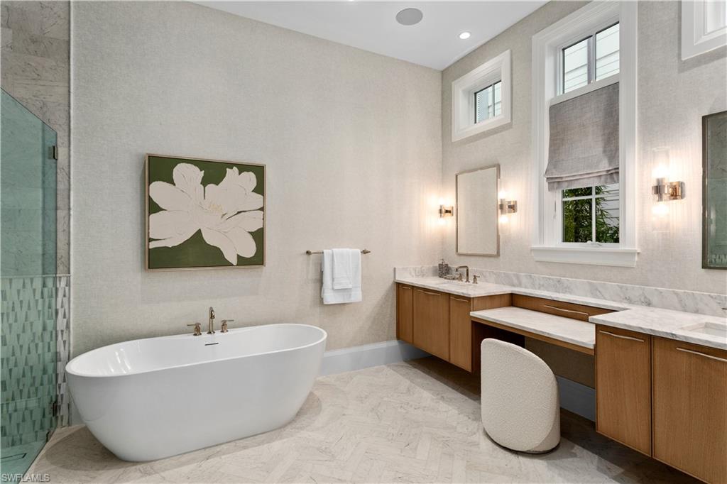 835 11th Avenue South Naples, FL 34102 - Photo 15 of 31 a spacious bathroom with a tub sink and mirror