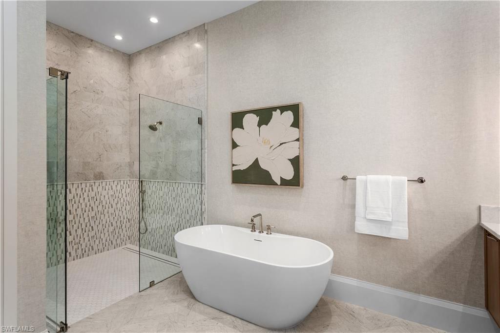 835 11th Avenue South Naples, FL 34102 - Photo 16 of 31 a bathroom with a bathtub and a shower