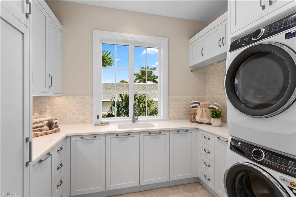 835 11th Avenue South Naples, FL 34102 - Photo 20 of 31 a kitchen with sink a washer and dryer