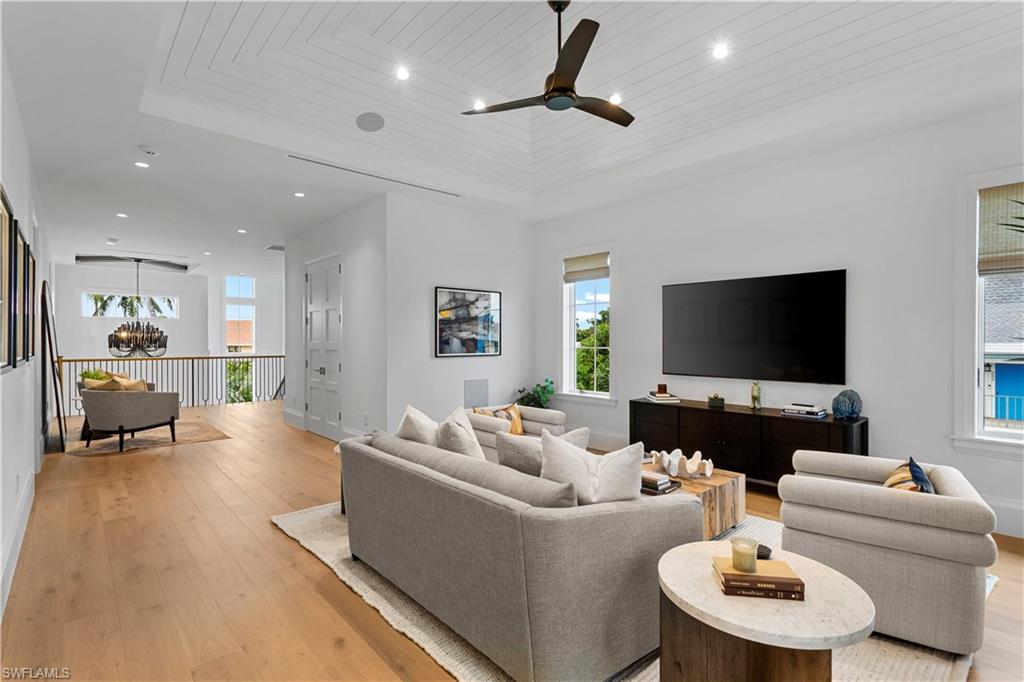835 11th Avenue South Naples, FL 34102 - Photo 21 of 31 a living room with furniture and a flat screen tv