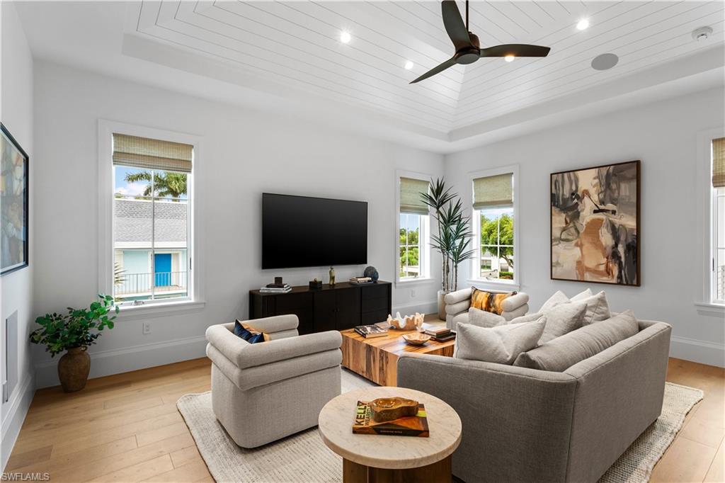 835 11th Avenue South Naples, FL 34102 - Photo 22 of 31 a living room with furniture and a flat screen tv
