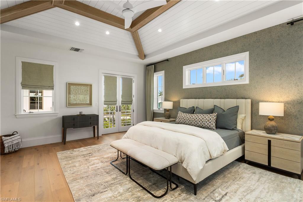 835 11th Avenue South Naples, FL 34102 - Photo 26 of 31 a bedroom with a large bed and a couch